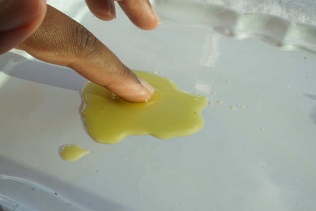 Finger in golden olive oil