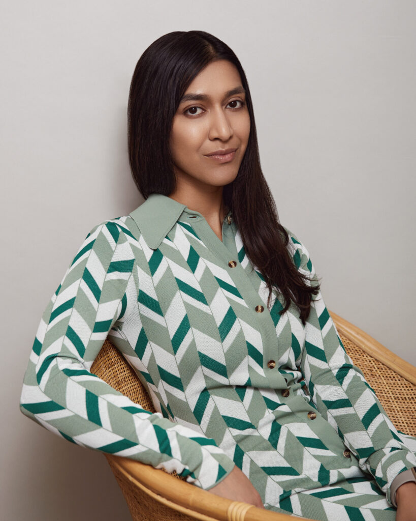 Break the Birdie and Break the Love Founder and CEO Trisha Goyal in green and white collared button down dress with chevron pattern